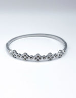 Silver bracelet with small stones on a white background