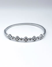 Silver bracelet with small stones on a white background
