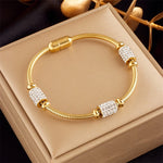 Hypoallergenic non-tarnish high polish gold crystal station bangle UAE.