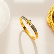 18K gold plated baguette crystal clover bangle by Biya Accessoires.