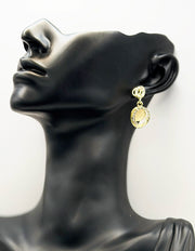 Close up of premium hypoallergenic imitation jewelry featuring a crystal circle and luminous stone.