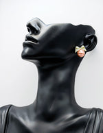 Sparkling crystal bow earrings with a luminous oversized faux pearl.