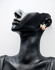 Sparkling crystal bow earrings with a luminous oversized faux pearl.