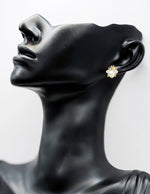 Close-up of premium hypoallergenic imitation jewelry featuring a pearl and crystal insect design.