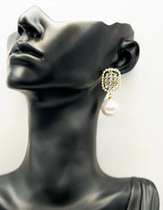 Close up of imitation jewelry uae statement drops featuring crystal studs and large pearl drops.