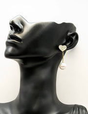 Close up of imitation jewelry uae statement drops featuring pavé crystal heart studs.