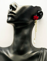 Close up of imitation jewelry uae statement drops featuring crimson rose and rhinestone chain.