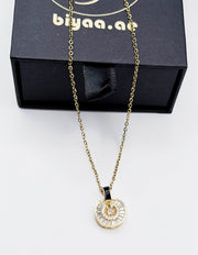 Biya Accessoires 18K gold plated baguette sunburst medallion necklace.