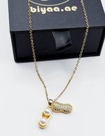 Close-up of premium hypoallergenic imitation jewelry featuring a quirky pearl pendant.