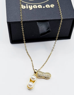 Close-up of premium hypoallergenic imitation jewelry featuring a quirky pearl pendant.