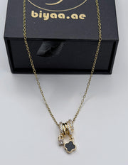 Biya Accessoires 18K gold plated triple ring necklace with black clover charm.