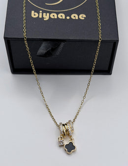Biya Accessoires 18K gold plated triple ring necklace with black clover charm.