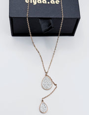 Model wearing an elegant rose gold lariat drop necklace in the UAE.