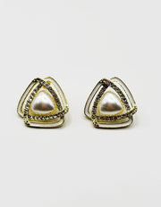 Close up of imitation jewelry uae statement studs featuring iridescent stones and pavé.