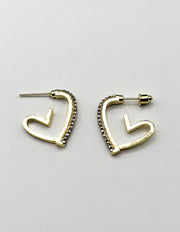 Close up of imitation jewelry uae heart hoops featuring clear pavé stones.