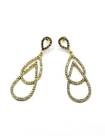 Close up of imitation jewelry uae statement earrings featuring pavé crystal figure-eight frames.