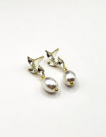 Close up of imitation jewelry uae statement earrings featuring marquise-cut crystal leaves.