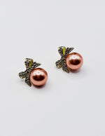 Biya Accessoires gold bow stud earrings with crystal pavé and large white pearl.