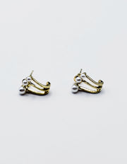 Biya Accessoires gold triple pearl claw earrings.