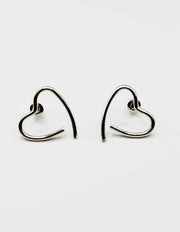 Biya Accessoires silver open heart ear crawler earrings.