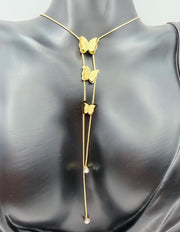 Gold butterfly necklace on a mannequin