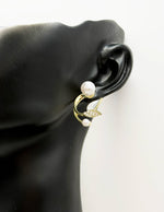 Biya Accessoires gold floral pearl ear jacket earrings.