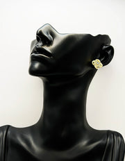 Close-up of premium hypoallergenic imitation jewelry featuring an interlocking gold design.