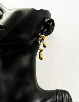Biya Accessoires 18K gold plated asymmetrical molten drop earrings.