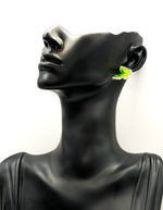 Close up of elegant imitation jewelry uae featuring a green gemstone butterfly and clear crystals.