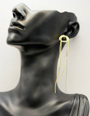Close up of elegant imitation jewelry uae featuring an intertwined gold knot and fine chain fringe.