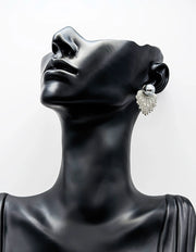 Mannequin head wearing a silver earring on a white background
