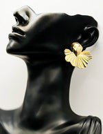 Close up of imitation jewelry uae statement gold jewelry uae fan earrings.