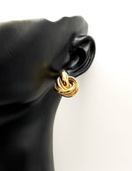 Close up of imitation jewelry uae statement gold jewelry uae knot earrings.