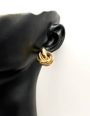Close up of imitation jewelry uae statement gold jewelry uae knot earrings.