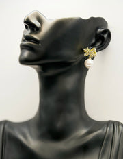Biya Accessoires gold crystal bow and pearl drop earrings.