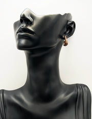 Close up of premium hypoallergenic imitation jewelry featuring a smooth brown sweep design.