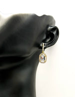Elegant green gemstone earrings with sparkling crystal border.