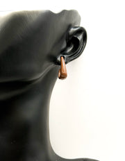 Everyday luxury fashion jewelry glossy neutral studs by Biya Accessoires Dubai.