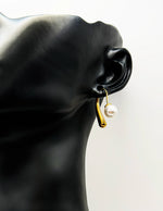 Close-up of premium hypoallergenic imitation jewelry featuring a sculptural gold pearl design.