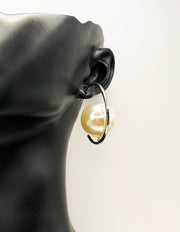 Biya Accessoires gold halo hoop earrings with floating oversized pearl.