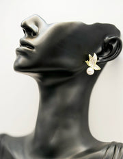 Close up of premium hypoallergenic imitation jewelry featuring a winged insect and pearl design.