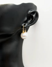 Close-up of premium hypoallergenic imitation jewelry featuring a round pearl and gold design.
