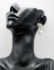 Close up of elegant imitation jewelry uae featuring a black enamel rose stud and faux pearl.