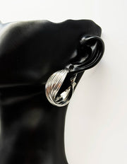 Biya Accessoires silver multi strand twisted hoop earrings.