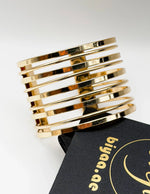 Non-tarnish layered gold bangle stack for women Dubai luxury fashion.