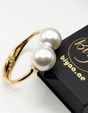 Hypoallergenic gold plated torque bracelet with oversized pearls United Arab Emirates.