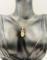 Hypoallergenic gold tiara and heart necklace with clear gemstone.