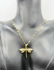 Waterproof gold insect jewelry with openwork wings on white silk.