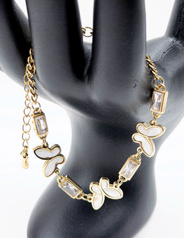18K gold plated pearlescent butterfly and baguette crystal bracelet by Biya Accessoires.