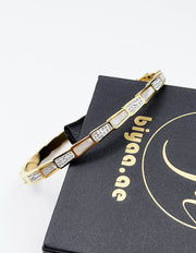Hypoallergenic non-tarnish high polish gold rigid geometric bangle UAE.